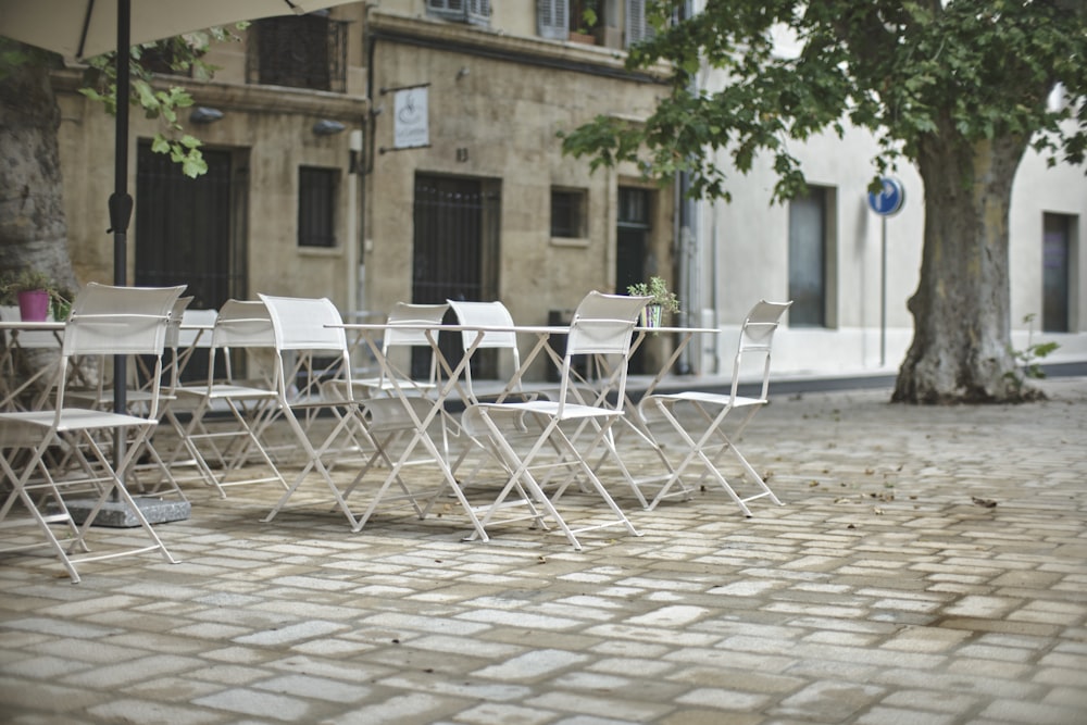 white folding chairs on brown brick floor