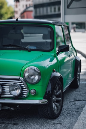 A sleek Mini 3 Door parked on a city street at sunset