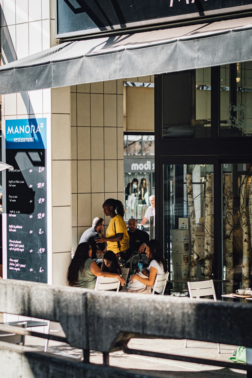 a group of people sitting outside of a building