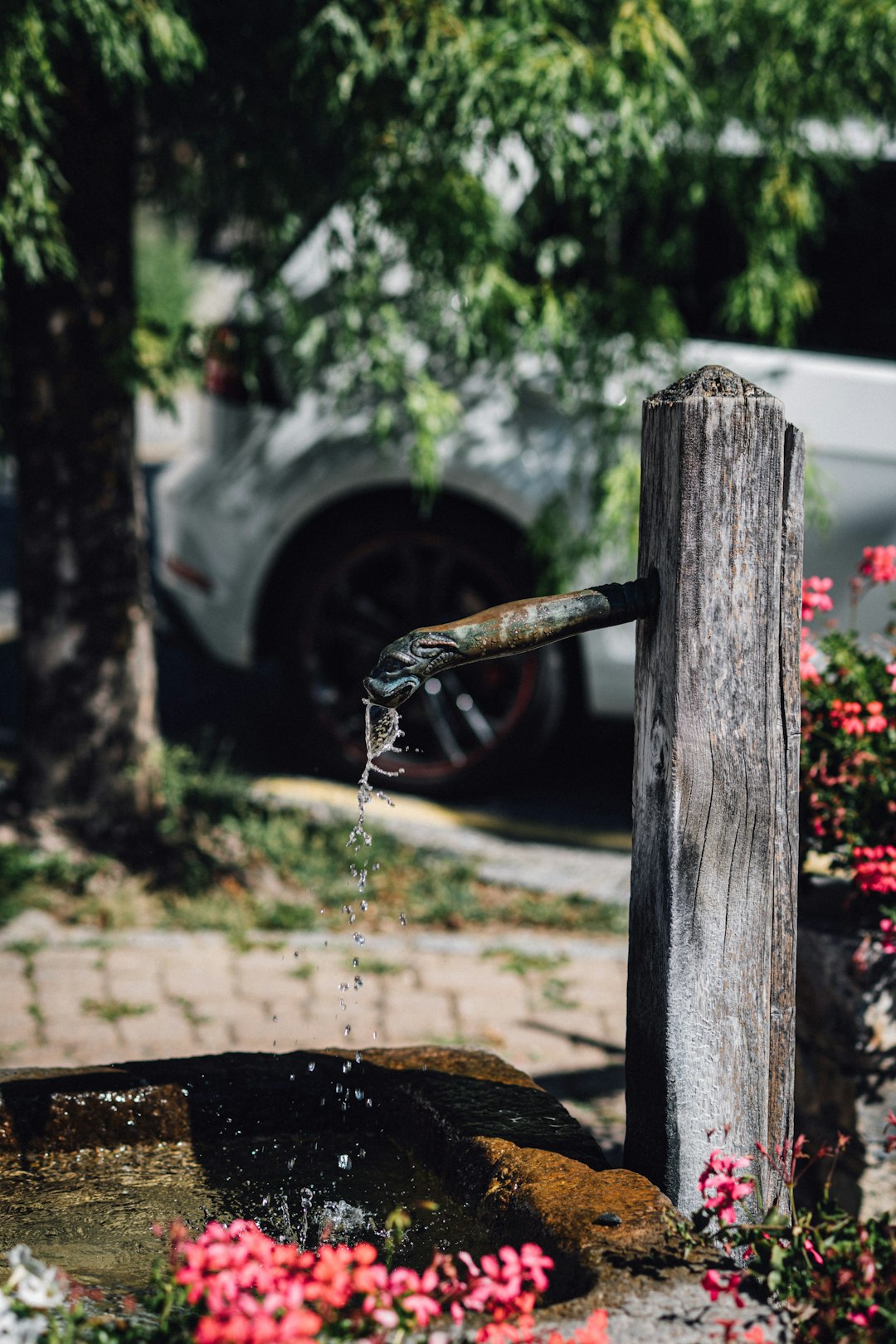 water falling from brown wooden post