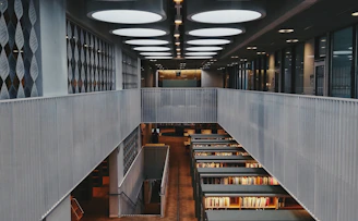brown wooden book shelves in library