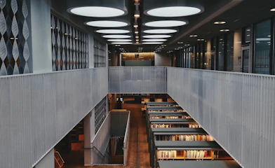 brown wooden book shelves in library