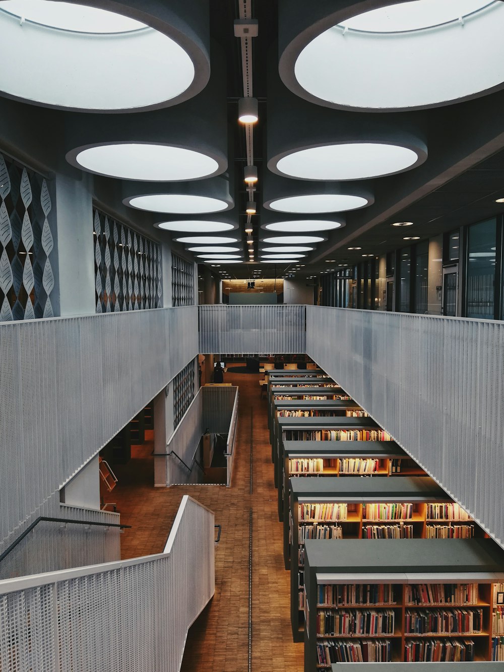 brown wooden book shelves in library