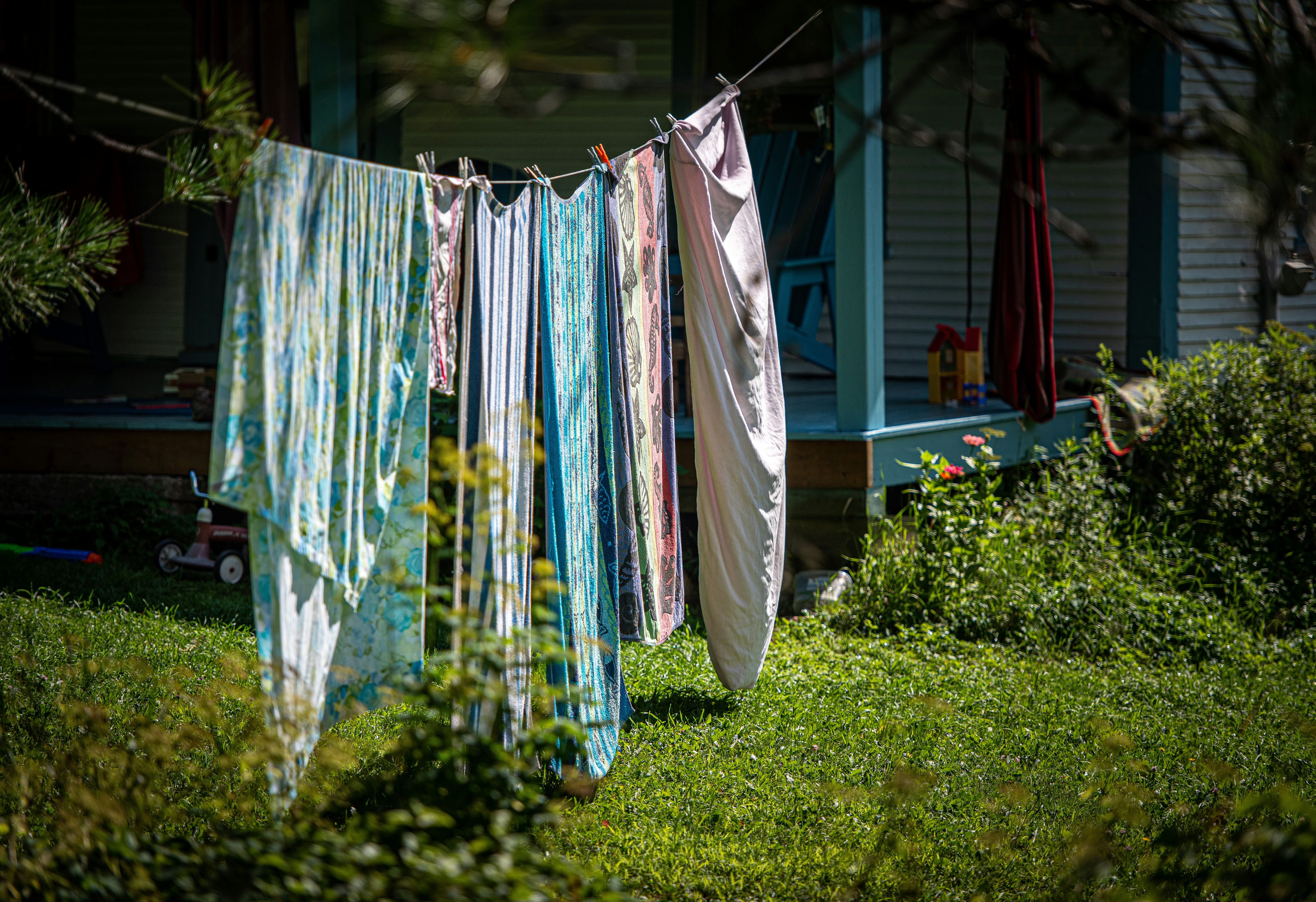 blue and white textiles hanged on wire during daytime