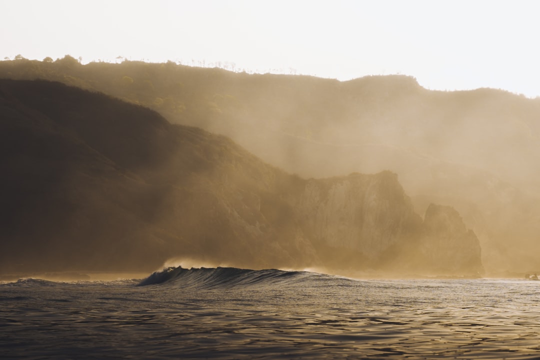 ocean waves crashing on shore during daytime