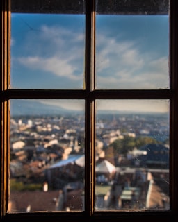 Close-up of a sparkling clean window with a cityscape of Barcelona in the background.