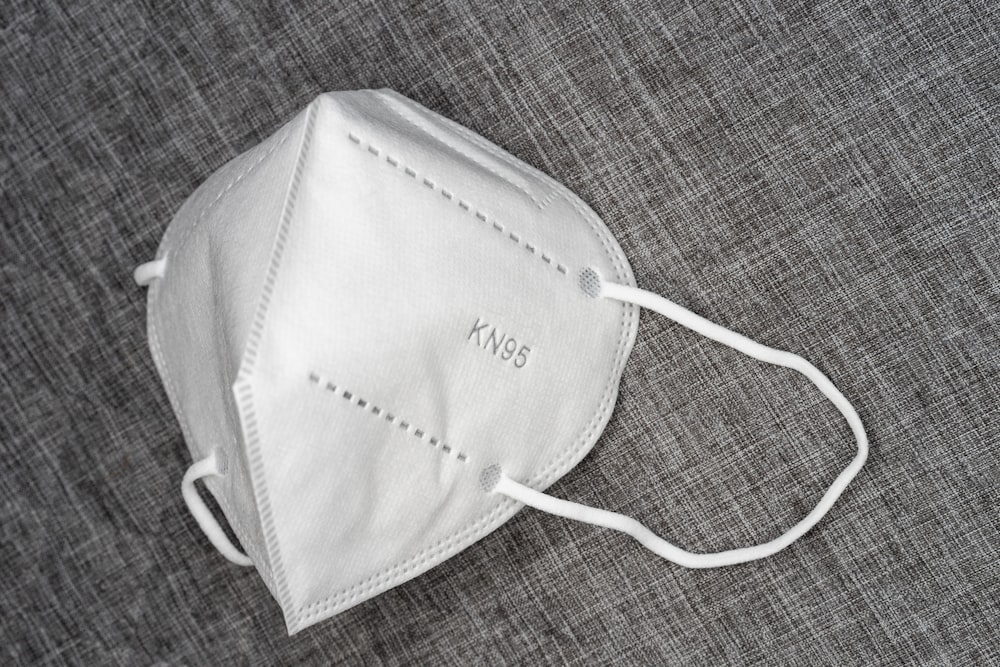 white leather sling bag on brown textile