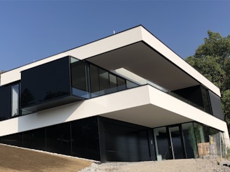 Completed modern small building with black and orange exterior in a scenic outdoor setting