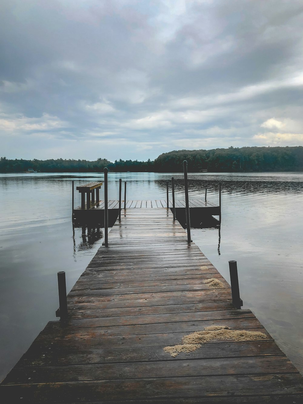 brown wooden dock on lake during daytime