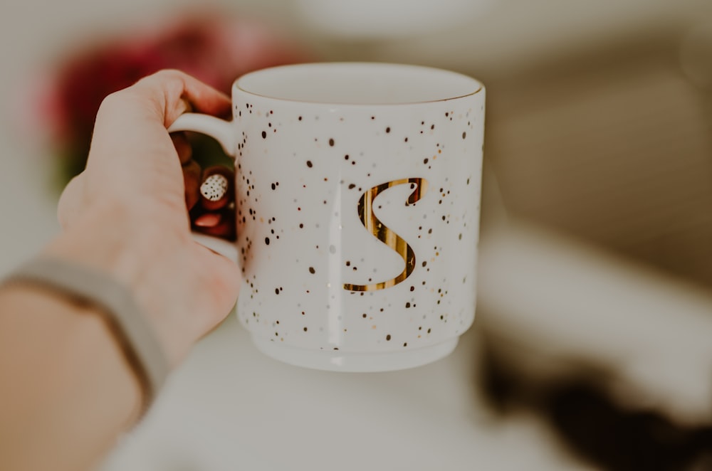 white and brown ceramic mug