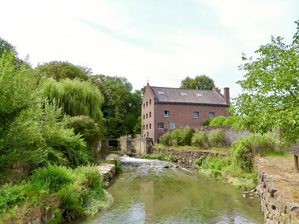 brown brick building beside river