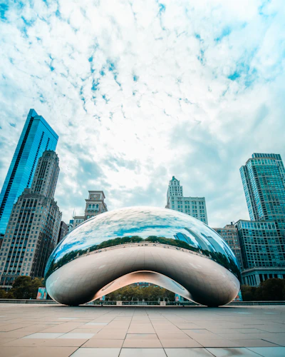 white and blue concrete building under white clouds and blue sky during daytime