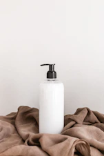 white plastic bottle on white table