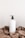 white plastic bottle on white table