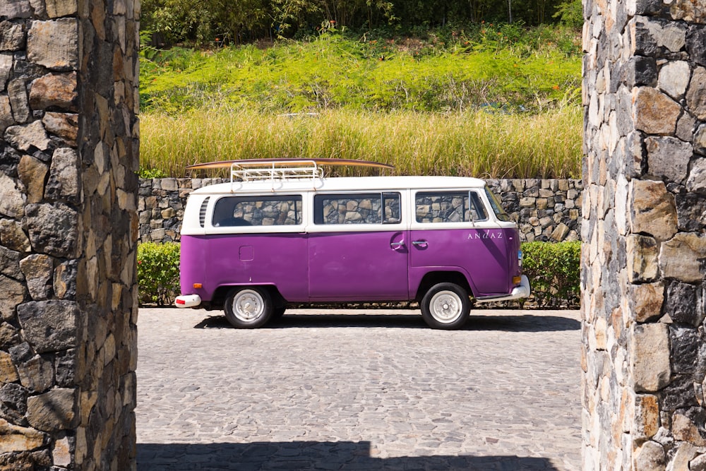 purple and white volkswagen t-2 on gray concrete road during daytime