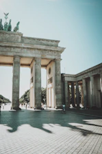 a large stone arch with statues on top of it