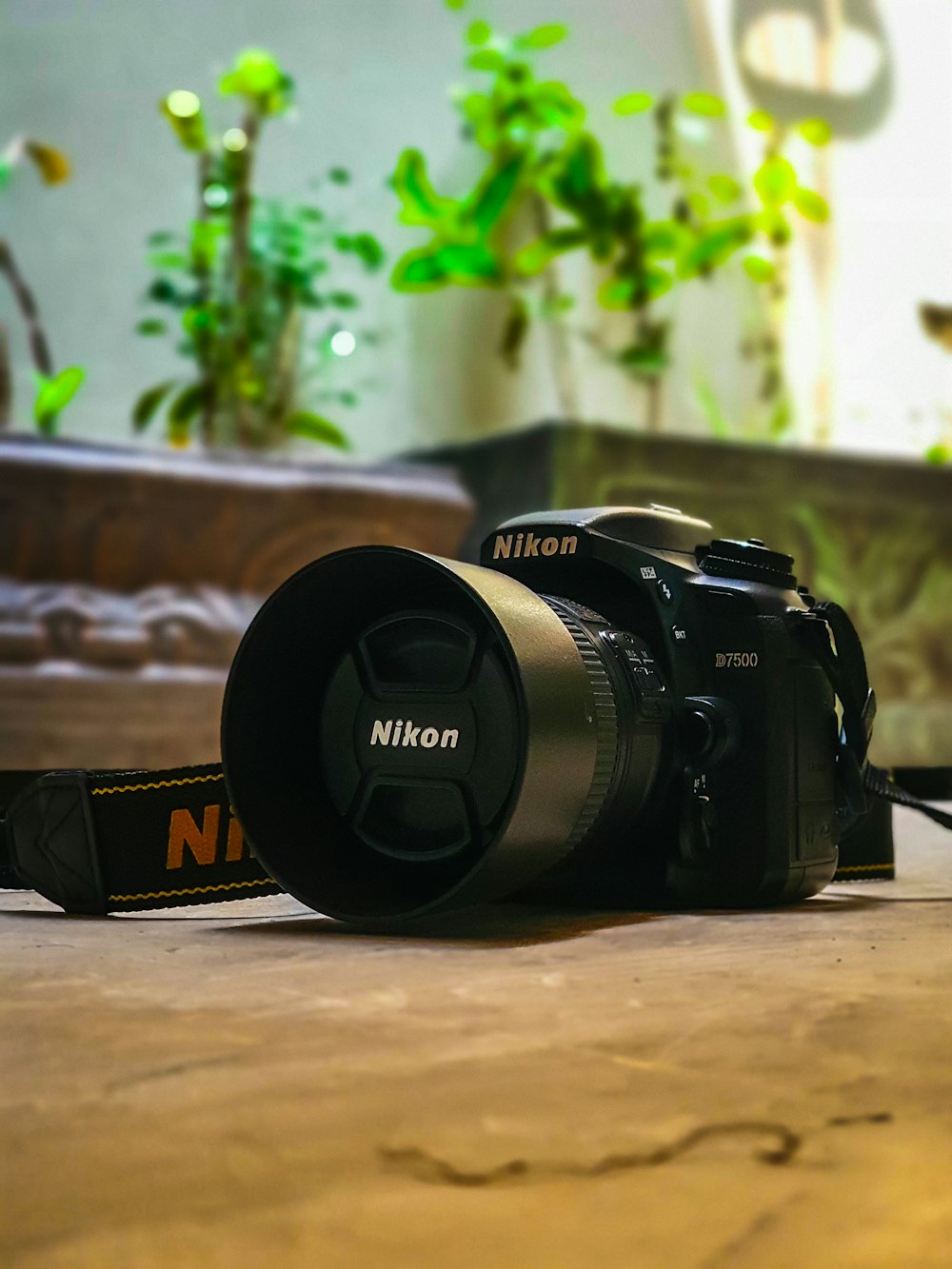 black nikon dslr camera on brown wooden table