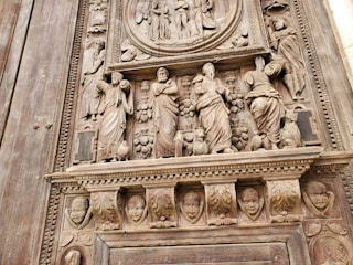 A close-up of a finely crafted veneered panel with artistic painted details.