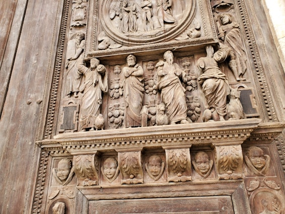 A close-up of a finely crafted veneered panel with artistic painted details.