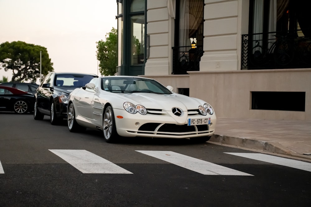 white bmw m 3 coupe parked on sidewalk during daytime