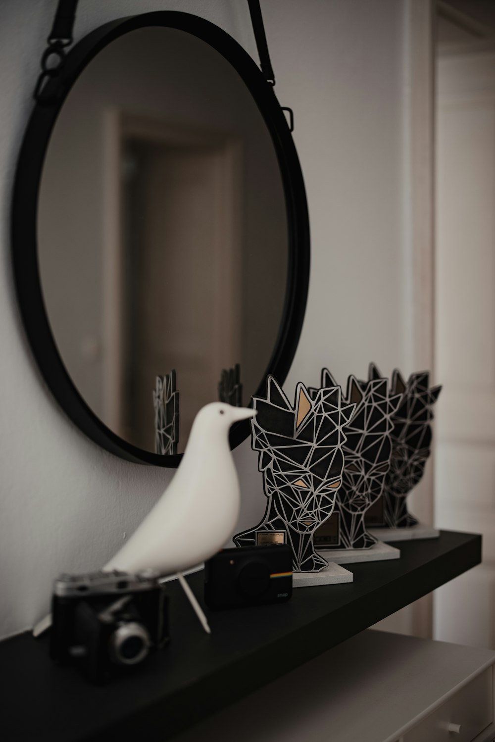 white bird figurine on white wooden table