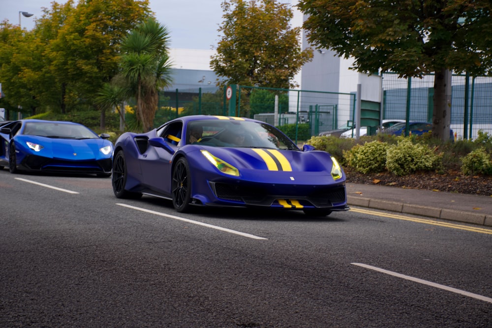 blue and black porsche 911 on road during daytime