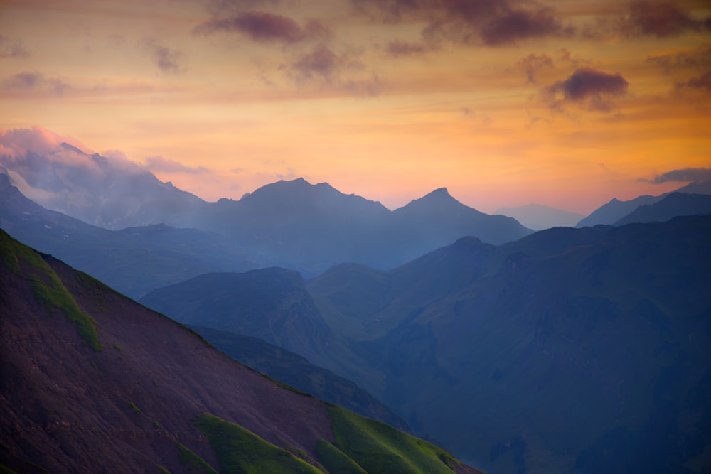 green mountains under white clouds during daytime