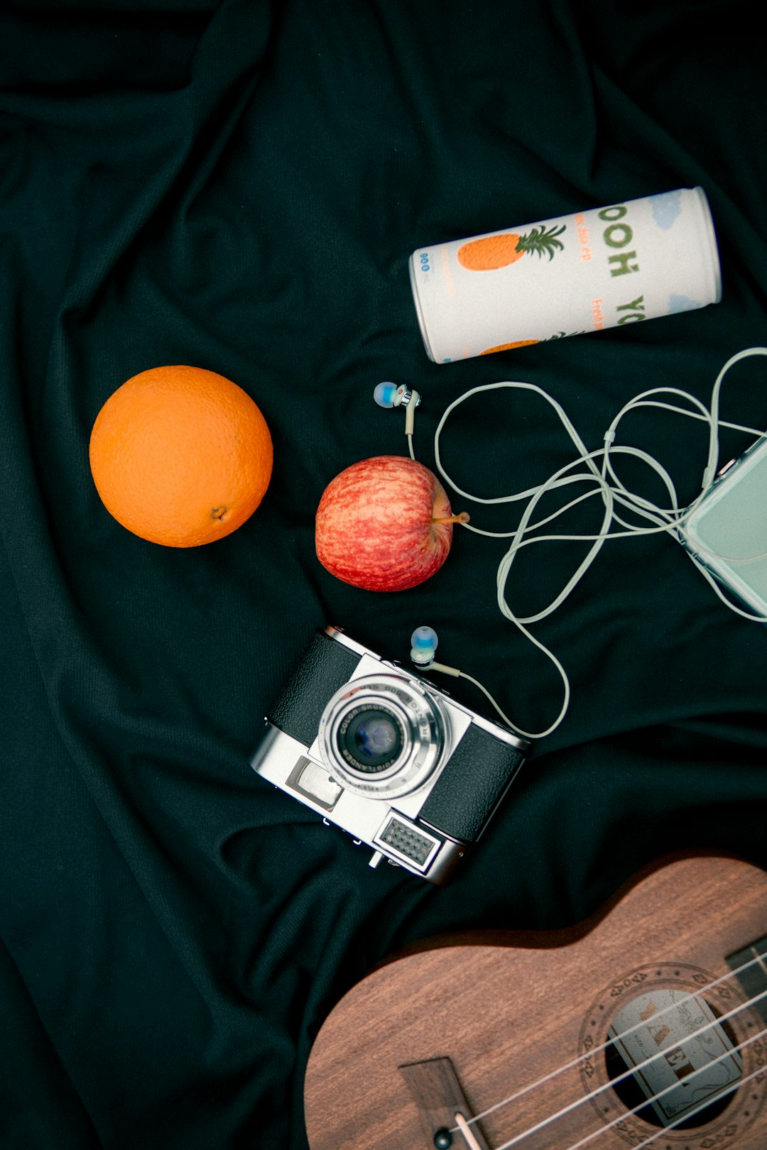 silver and black camera beside orange fruit