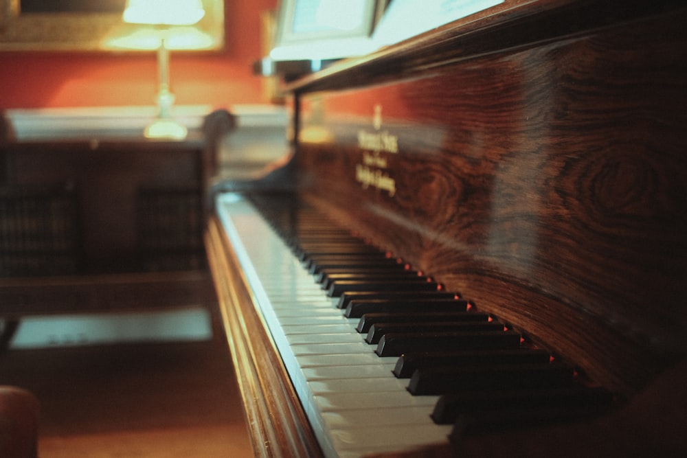 brown upright piano in close up photography