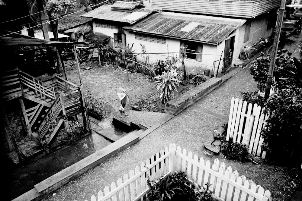 grayscale photo of wooden fence