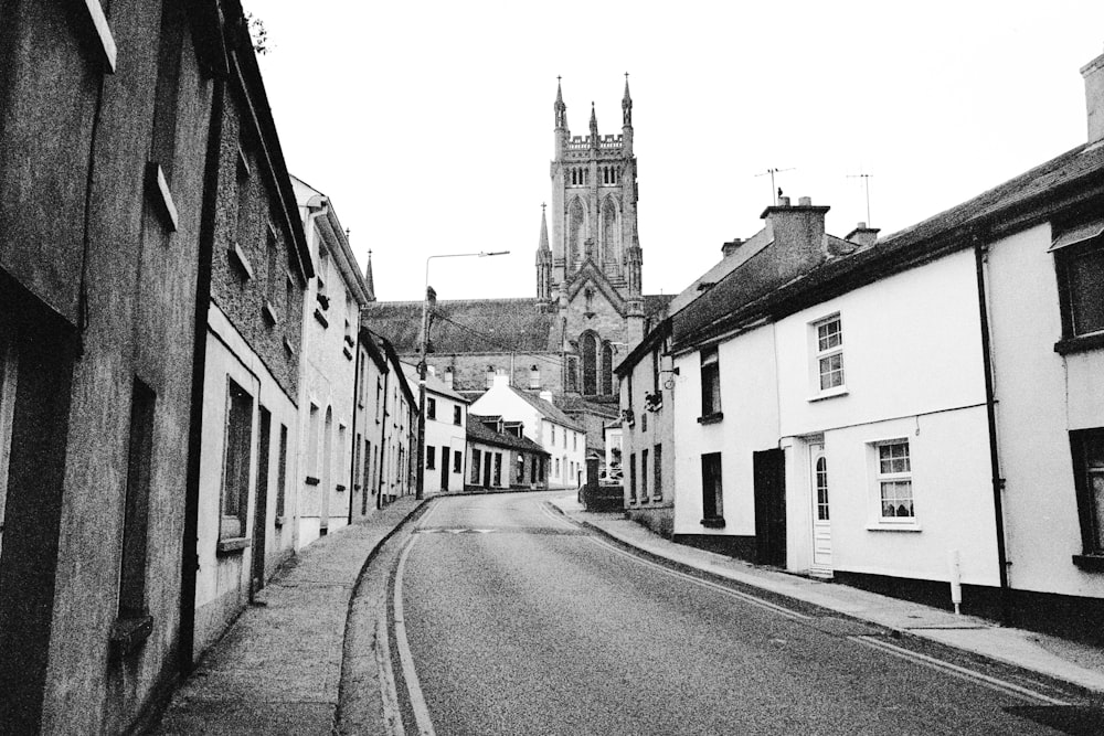 grayscale photo of a street in between buildings