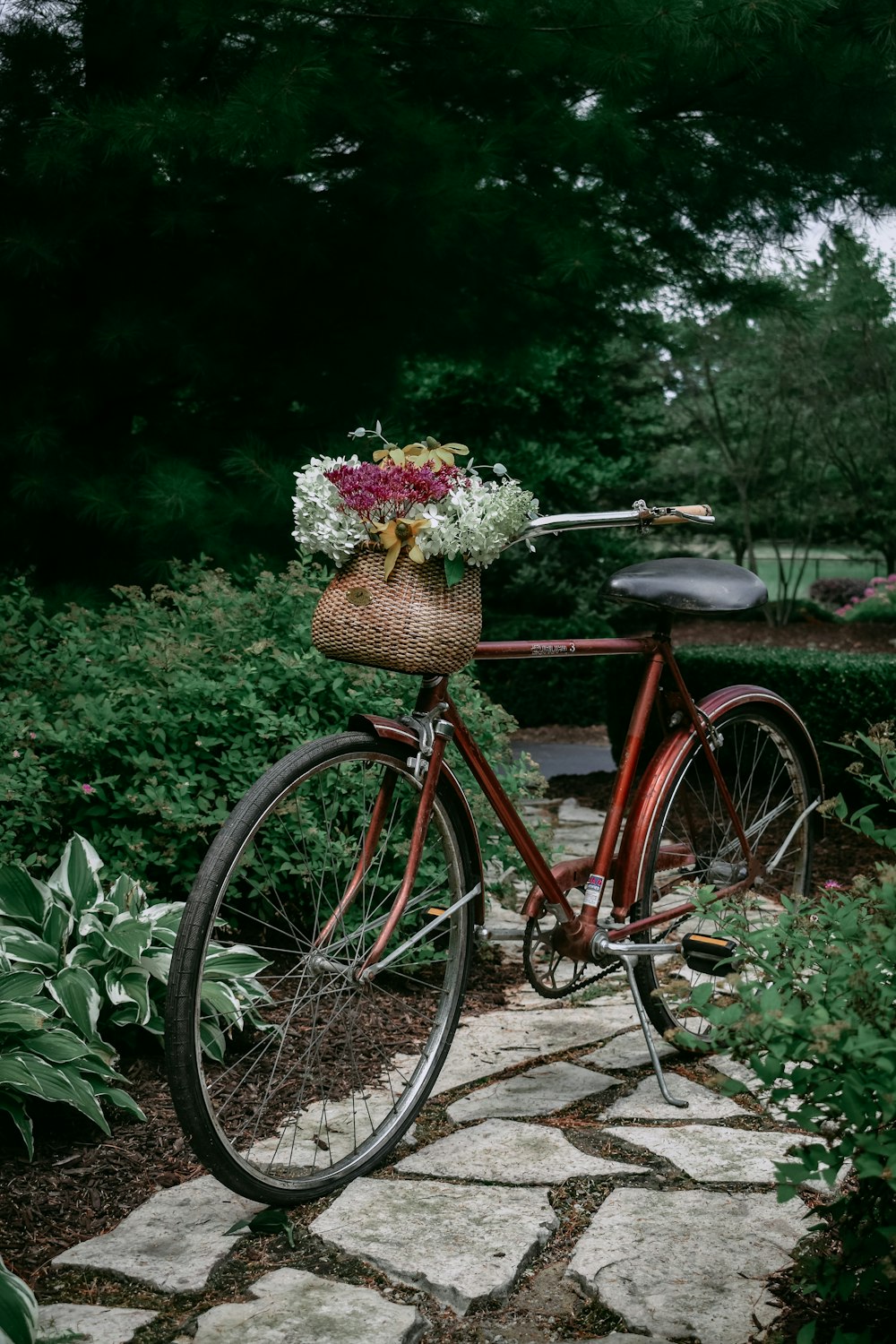 red city bike with basket of flowers