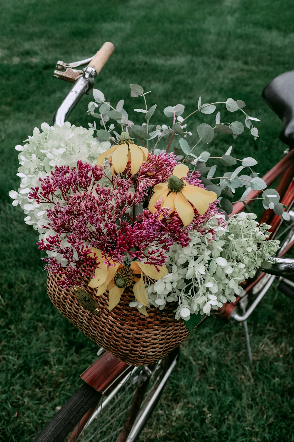 pink and white flowers in brown woven basket