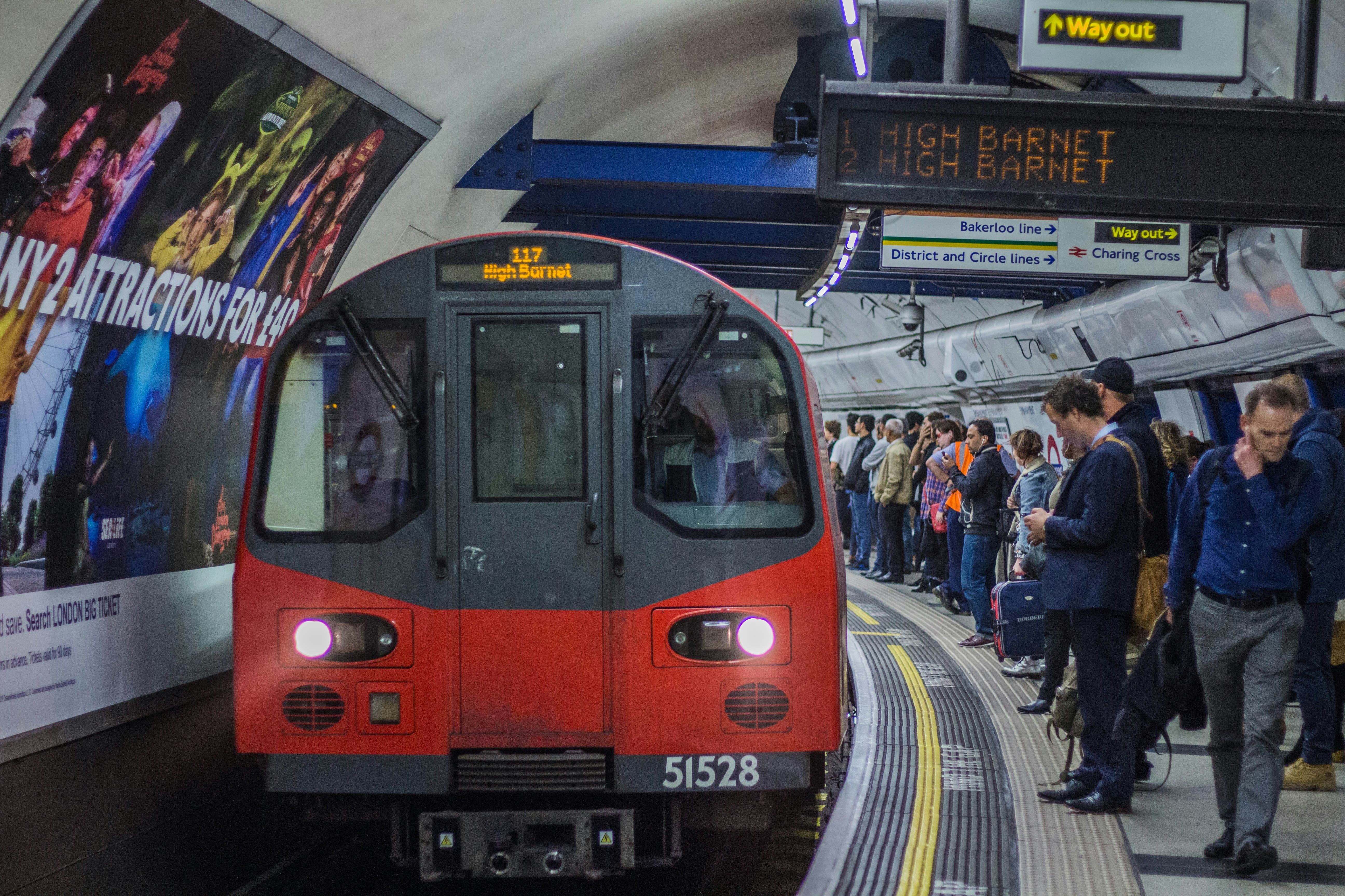 red and black train in the city during daytime, UK