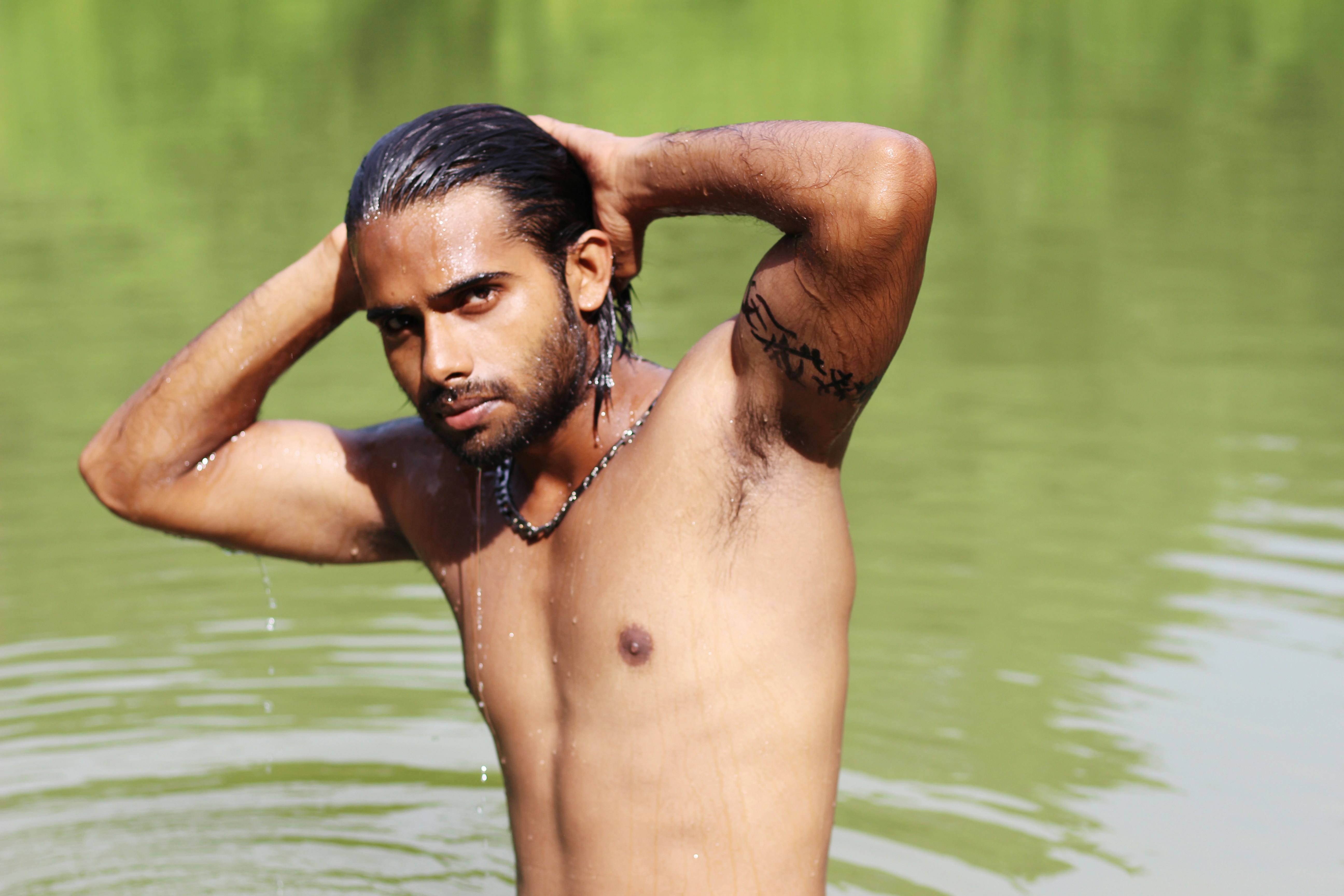 topless man in water during daytime