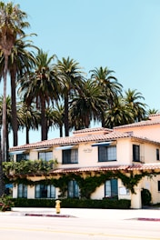 A friendly consultant discussing Title 24 reports with a contractor on a sunny San Diego construction site.