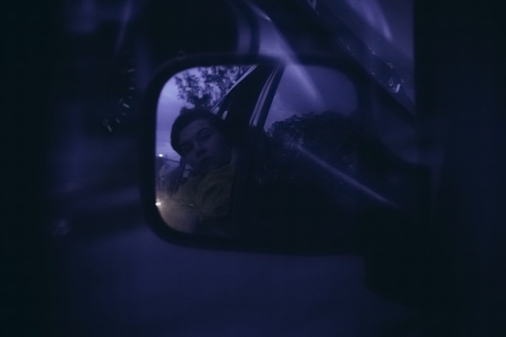 man in black sunglasses taking selfie in car