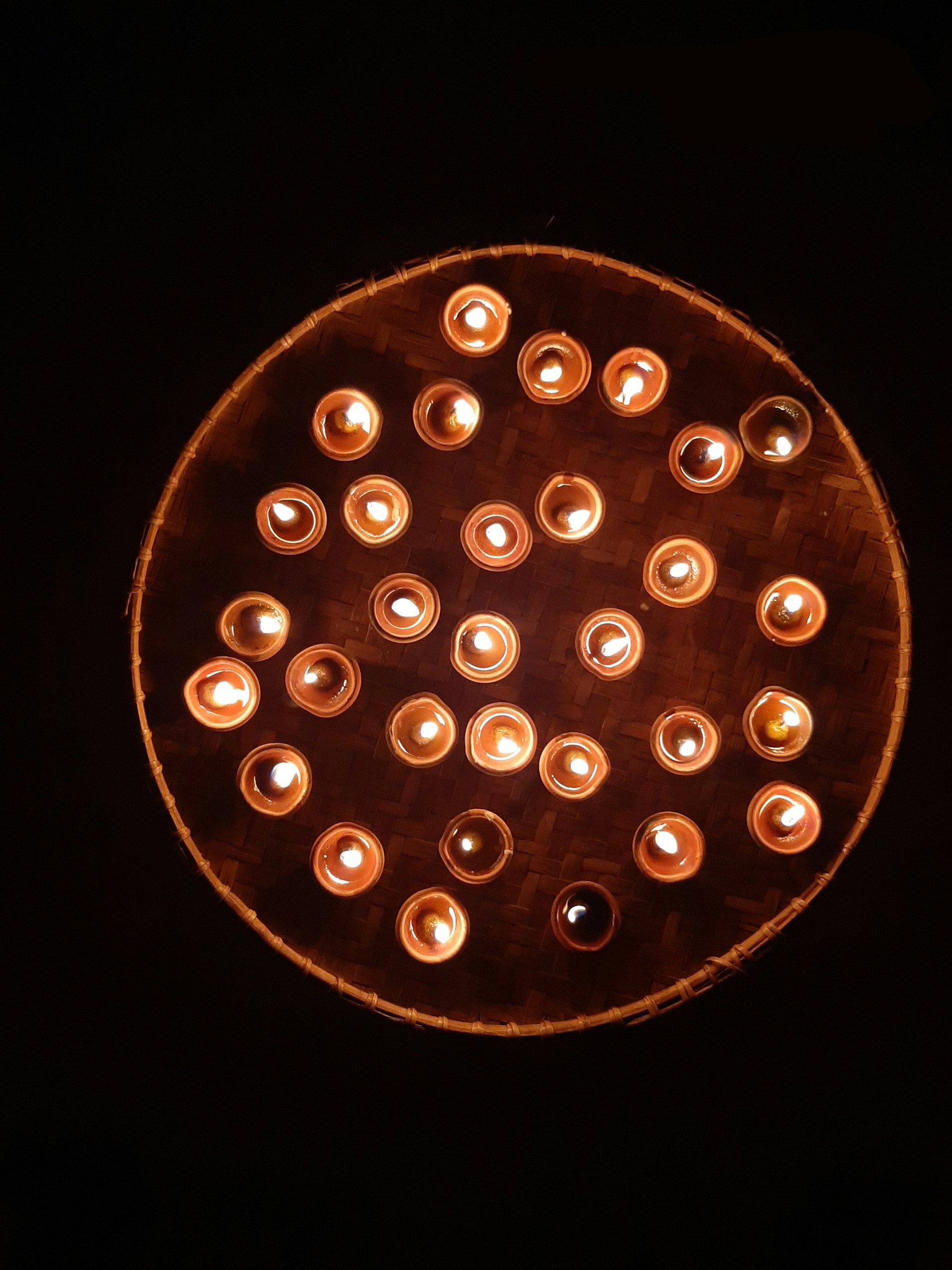 An inviting scene of a tranquil meditation circle with candles and soft cushions under a canopy of trees.