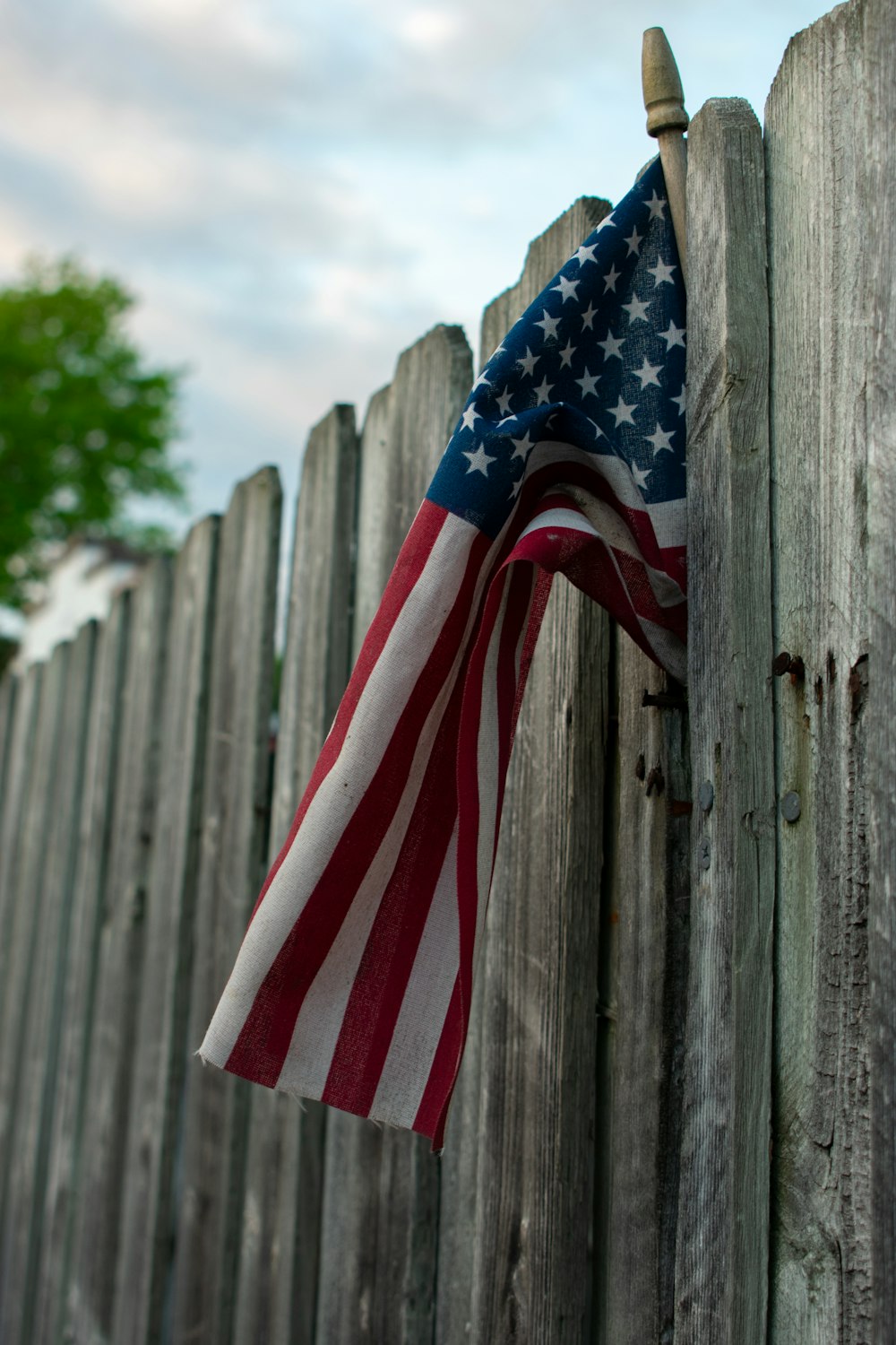 us a flag on wooden fence