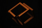 orange letter x on black background