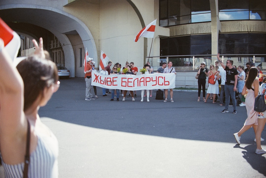 people standing in front of UNKs stadium during daytime