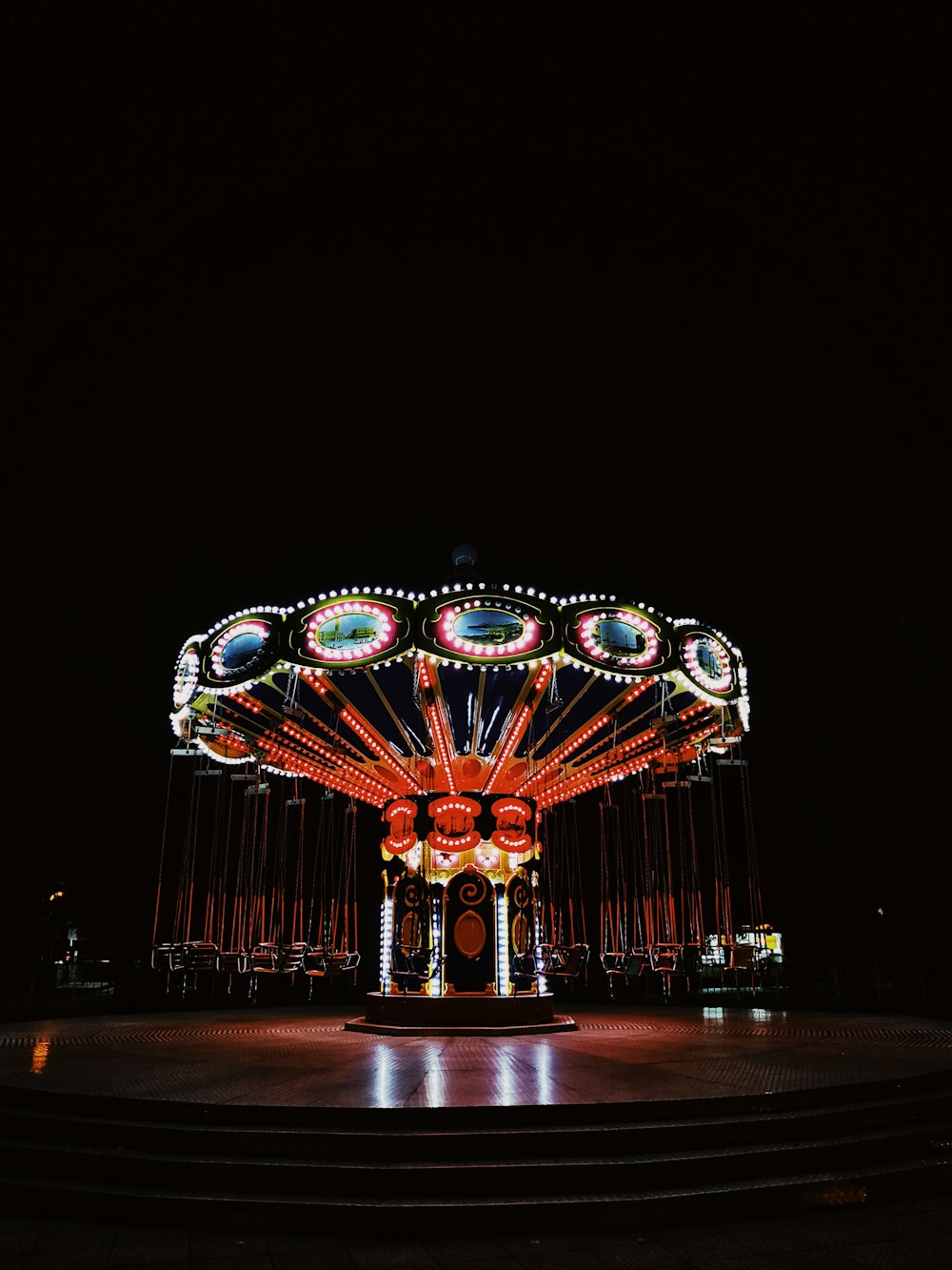 lighted carousel with lights during night time