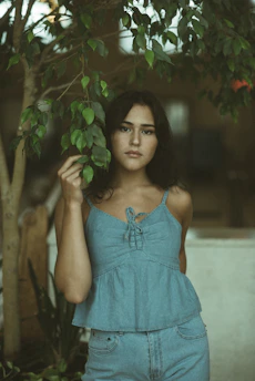 A calm person consulting a naturopathy expert online with herbal plants in the background.