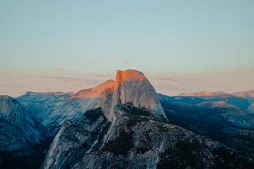 A stunning high-resolution photo capturing Monterrey's iconic Cerro de la Silla at sunset with soft, warm light.
