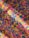 A vibrant assortment of colorful rice grains scattered in a mixed pattern. The colors include bright pink, yellow, and blue, creating a lively and playful mosaic effect.