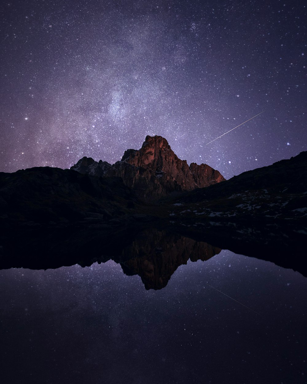 brown mountain under starry night