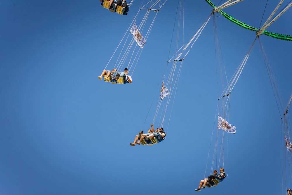 people riding on yellow and black cable car under blue sky during daytime