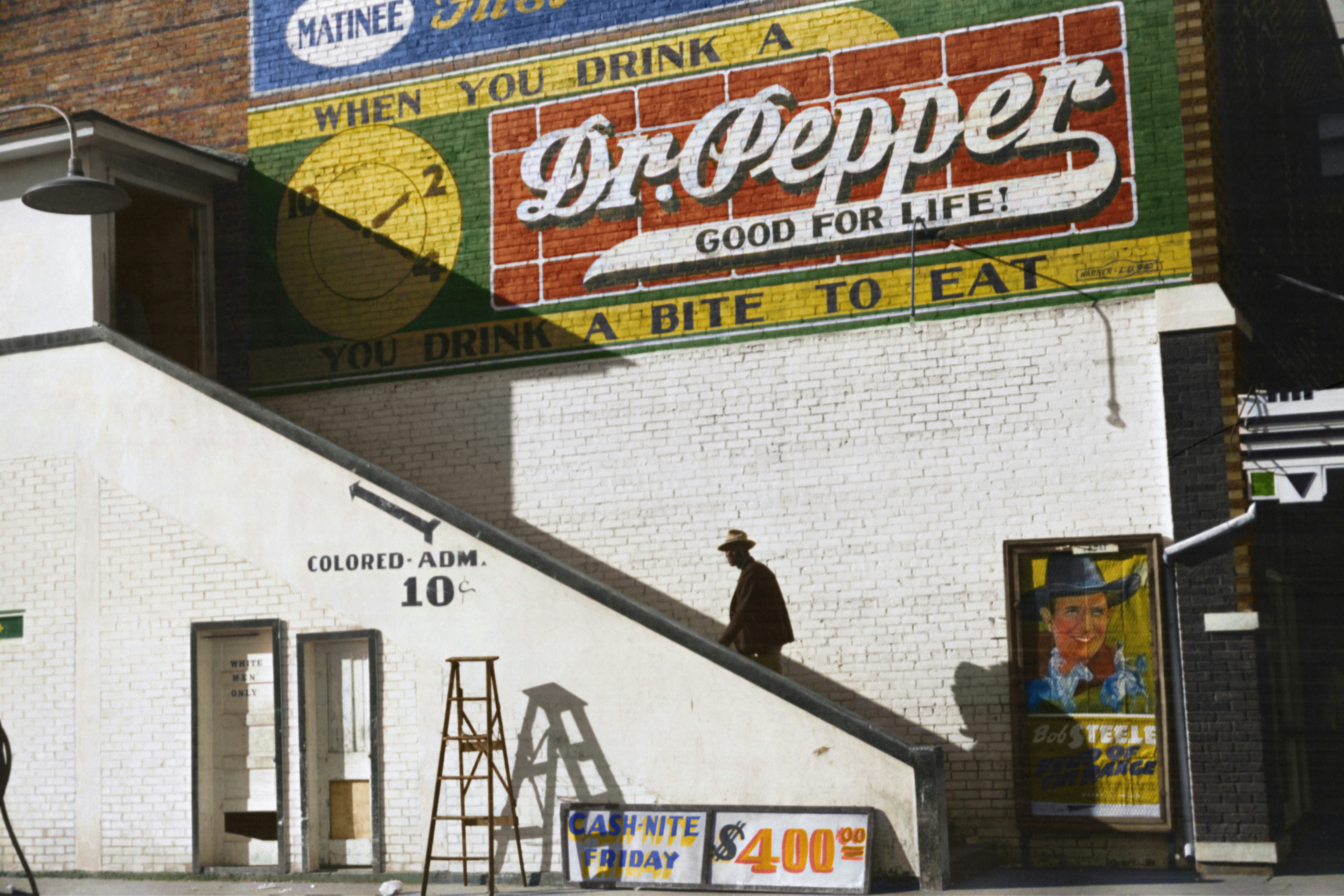 Caption reads, "Negro going in colored entrance of movie house on Saturday afternoon, Belzoni, Mississippi Delta, Mississippi." Original black and white negative by Marion Post Wolcott. Taken October, 1939, Belzoni, MS, United States (@libraryofcongress). Colorized by Jordan J. Lloyd. Library of Congress Prints and Photographs Division Washington, D.C. 20540 https://www.loc.gov/pictures/item/2017754826/