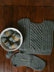 Artisan’s hands carefully knitting a warm scarf with natural wool yarn