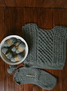 Artisan’s hands carefully knitting a warm scarf with natural wool yarn